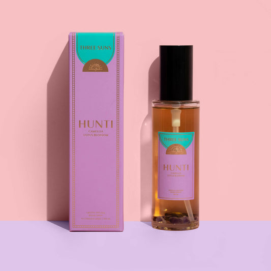 Hunti Crystal Infused Room Spray with black lid, calming Camellia, Lotus Blossom, and Sandalwood scent, infused with Amethyst and Tiger’s Eye crystals, luxury perfume spray Australia by Three Suns.